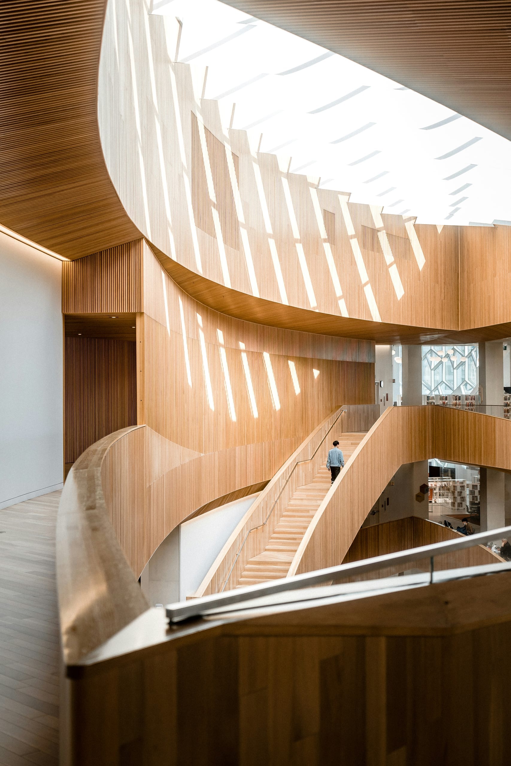 A staircase rising through an open, light-filled interior
